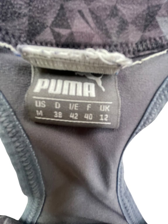 PUMA reggiseno sportivo con motivo geometrico logo viola/nero da donna M